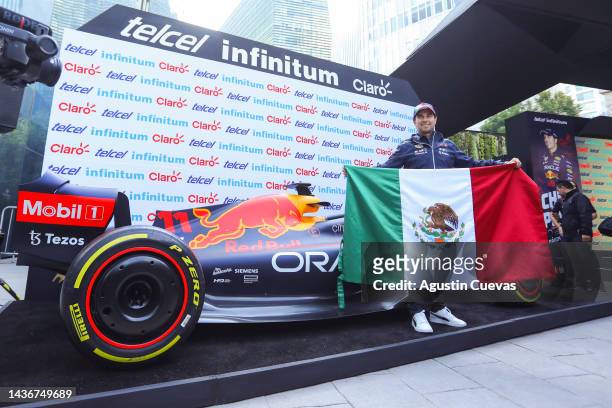 Formula 1 and Oracle Red Bull Racing driver Sergio Perez poses with the Mexican flag during a press conference ahead of Mexico F1 Grand Prix at...