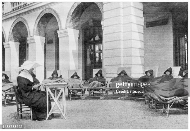 antique image: hopital de villiers, outdoor rest - nun hospital stock illustrations