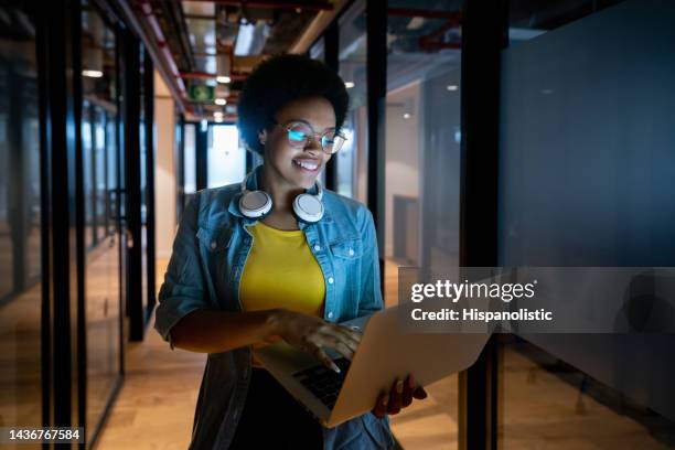 it technician working late at the office using her laptop - data scientist stock pictures, royalty-free photos & images
