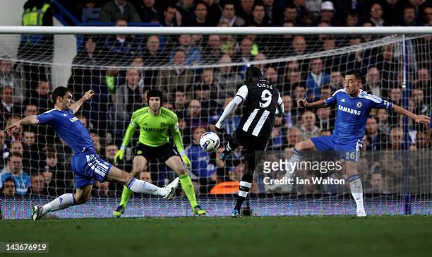 Papiss Cisse of Newcastle scores the opening goal despite the efforts from Branislav Ivanovic and John Terry of Chelsea during the Barclays Premier...