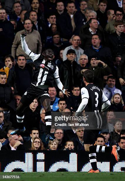 Papiss Cisse of Newcastle celebrates after scoring the opening goal with teammate Davide Santon during the Barclays Premier League match between...