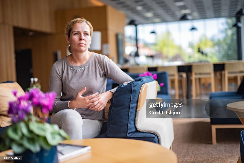 Premium Photo  Pensive woman sitting at table while thinking