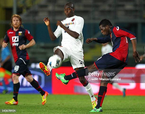 Victor Ibarbo of Cagliari Calcio competes for the ball with Masahudu Alhassan of Genoa CFC during the Serie A match between Genoa CFC and Cagliari...