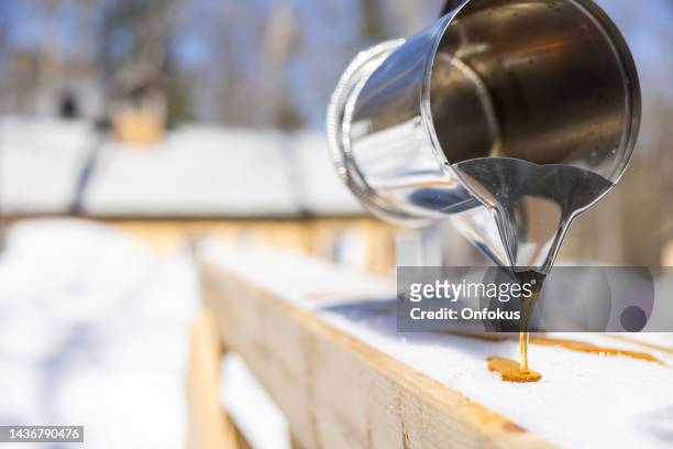 maple sugar taffy on snow at sugar shack - sugar shack stockfoto's en -beelden
