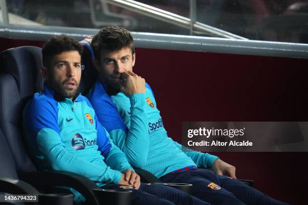 Jordi Alba and Gerard Pique of FC Barcelona look on from the bench prior to the UEFA Champions League group C match between FC Barcelona and FC...