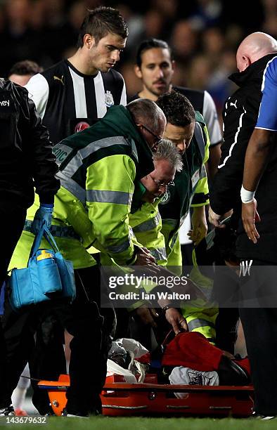 Cheick Tiote of Newcastle receives medical treatment during the Barclays Premier League match between Chelsea and Newcastle United at Stamford Bridge...