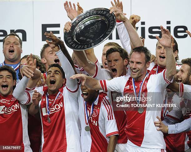 Ajax Amsterdam players hold the Dutch Eredivisie league trophy after secured their 31st title by beating VVV-Venlo 2-0 on May 2, 2012 in Amsterdam. A...