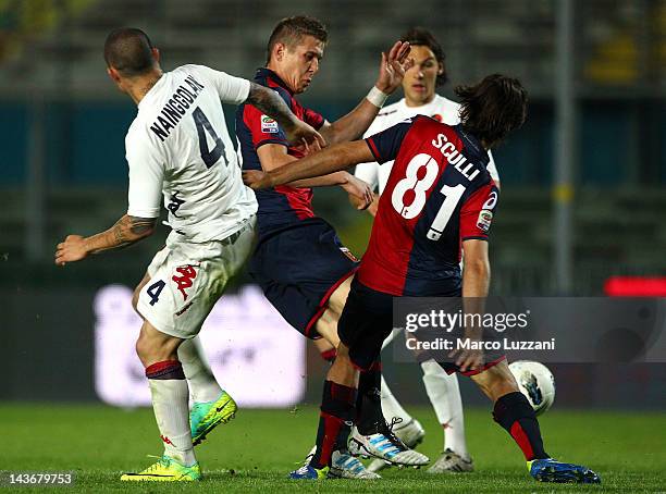 Radja Nainggolan of Cagliari Calcio competes for the ball with Juraj Kucka and Giuseppe Sculli of Genoa CFC during the Serie A match between Genoa...