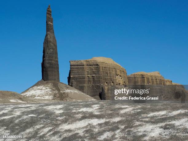 pinnacle rock formation called "the spire" or "long dong silver" at the mancos badlands, north caineville mesa, utah - pinnacle rock formation fotografías e imágenes de stock