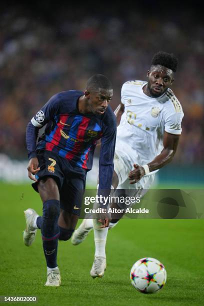 Ousmane Dembele of FC Barcelona is challenged by Alphonso Davies of Bayern Munich during the UEFA Champions League group C match between FC Barcelona...