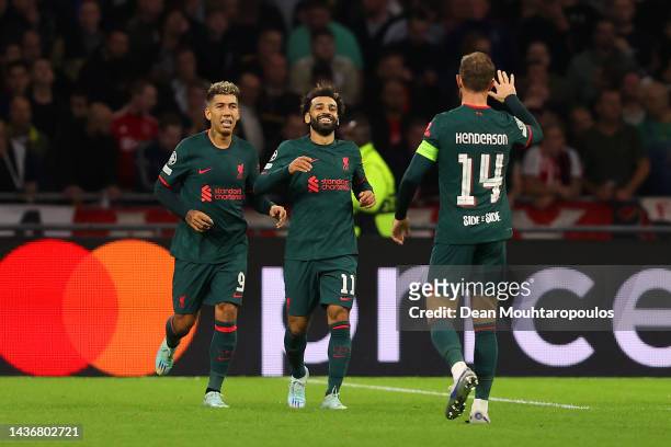 Mohamed Salah of Liverpool celebrates with teammates after scoring their team's first goal during the UEFA Champions League group A match between AFC...