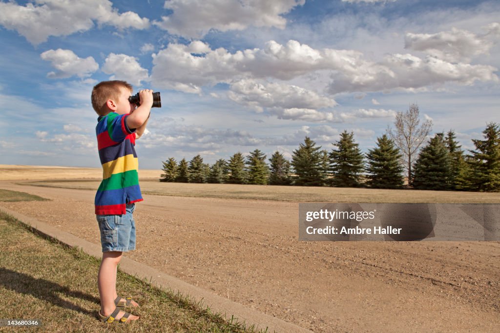 Boy looking through binoculars