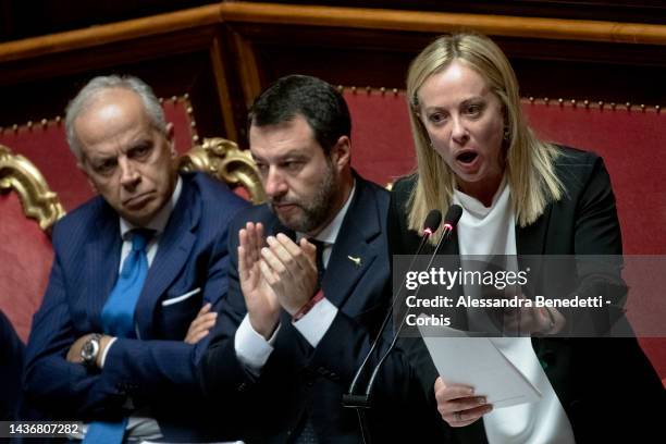 Italy's Prime Minister Giorgia Meloni speaks, flanked by Interior Minister Matteo Piantedosi and Minister of Sustainable Infrastructure and Mobility...