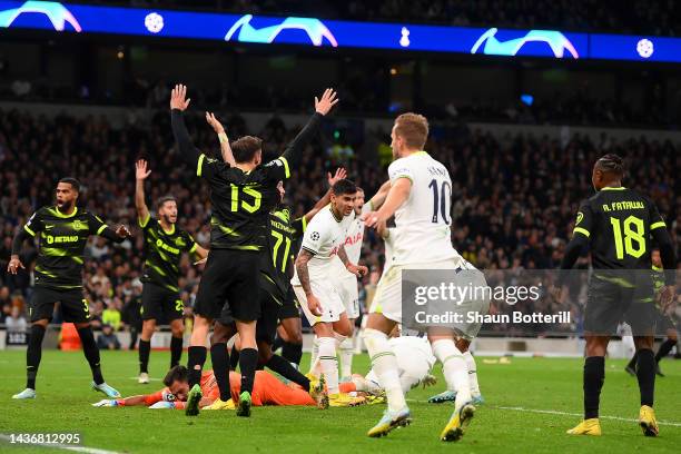 Rodrigo Bentancur of Tottenham Hotspur celebrates with teammates after scoring their side's first goal as players of Sporting CP react during the...