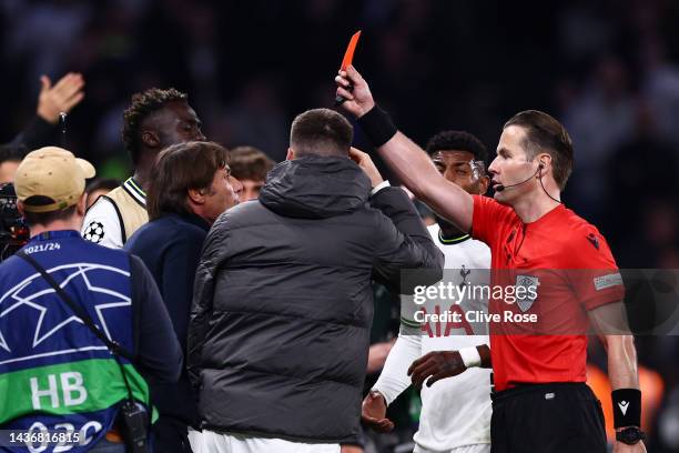 Match referee, Danny Makkelie shows Antonio Conte, Manager of Tottenham Hotspur a red card during the UEFA Champions League group D match between...