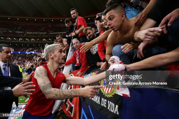 Antoine Griezmann of Atletico Madrid hands their shirt to fans after their sides draw during the UEFA Champions League group B match between Atletico...