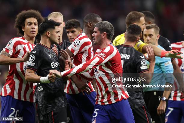 Rodrigo De Paul of Atletico Madrid clashes with Nadiem Amiri of Bayer 04 Leverkusen during the UEFA Champions League group B match between Atletico...