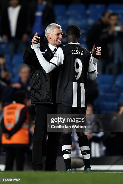 Alan Pardew the Newcastle manager celebrates with two goal hero Papiss Cisse of Newcastle after the final whistle during the Barclays Premier League...