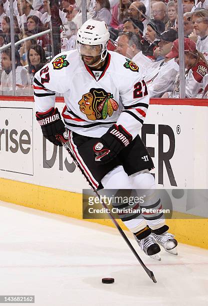 Johnny Oduya of the Chicago Blackhawks skates with the puck in Game Five of the Western Conference Quarterfinals against the Phoenix Coyotes during...