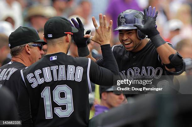 Wilin Rosario of the Colorado Rockies celebrates his solo homerun off of starting pitcher Clayton Kershaw of the Los Angeles Dodgers with Marco...