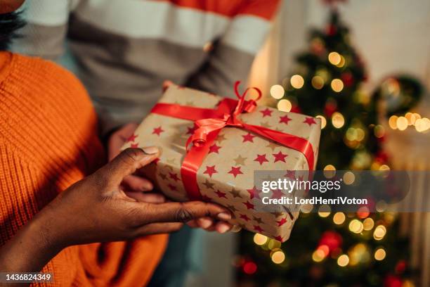 woman receiving a present from her boyfriend - exchanging gifts stock pictures, royalty-free photos & images
