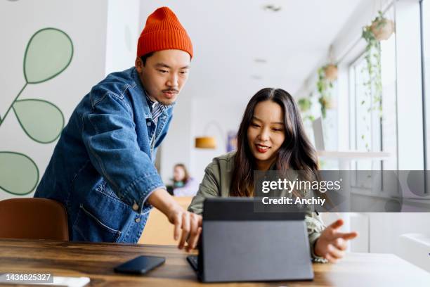 coworkers team at work. group of young business people in trendy casual wear working together in creative office - man business looking up stockfoto's en -beelden