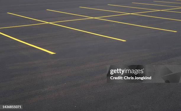 parking spaces painted on fresh asphalt - parking space stock pictures, royalty-free photos & images