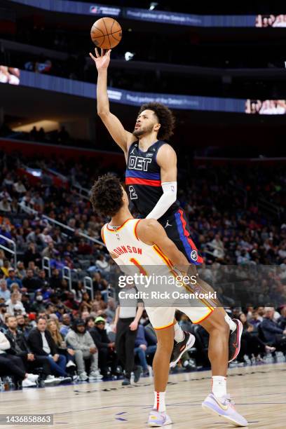 Cade Cunningham of the Detroit Pistons is fouled by Jalen Johnson of the Atlanta Hawks while shooting in the second half at Little Caesars Arena on...