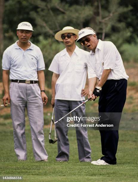 Chinese Premier Zhao Ziyang golfing with unidentified others, Beijing, China, late 1980s.