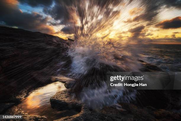 waves and sand - waves crashing on rocks stock pictures, royalty-free photos & images