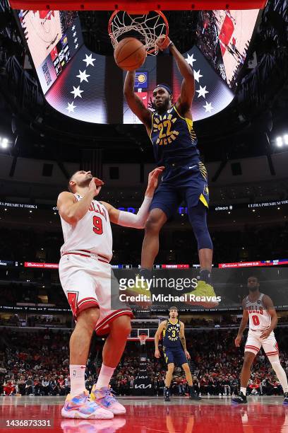 Isaiah Jackson of the Indiana Pacers dunks over Nikola Vucevic of the Chicago Bulls during the second half at United Center on October 26, 2022 in...