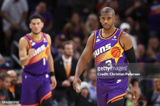 Chris Paul of the Phoenix Suns reacts after hitting a three-point shot at the end of the first half of the NBA game at Footprint Center on October...
