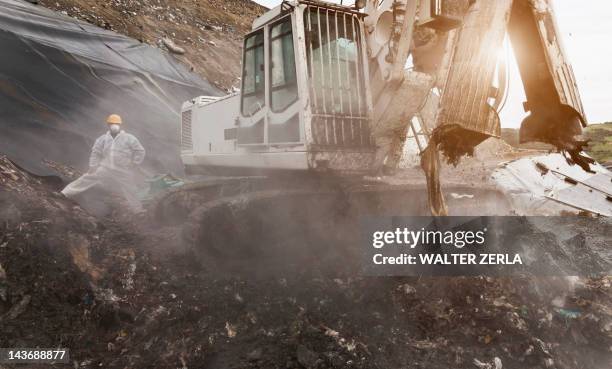 digger at garbage collection center - methane stock pictures, royalty-free photos & images