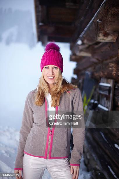 smiling woman standing in snow - lech austria stock pictures, royalty-free photos & images