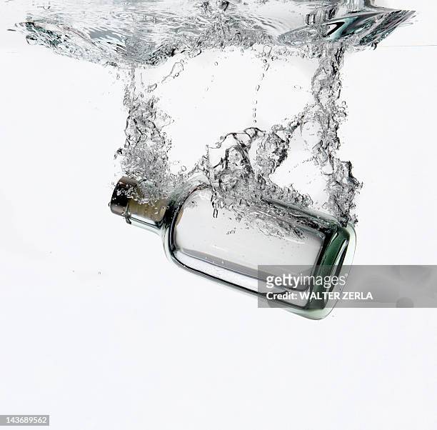bottle splashing in water - aquatic ストックフォトと画像