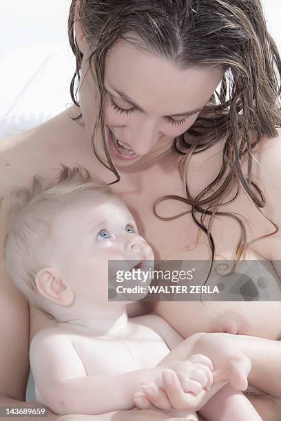 nude mother holding baby - birthday suit stock pictures, royalty-free photos & images