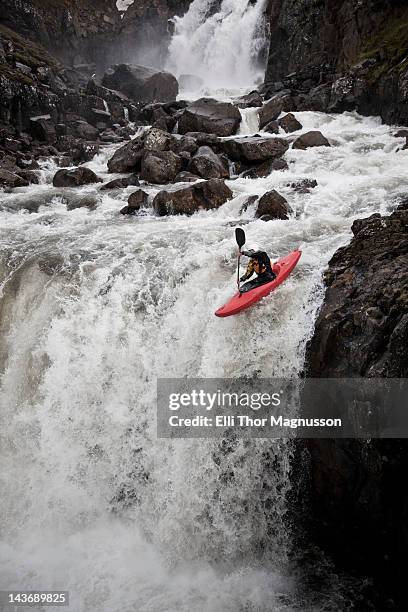 man canoeing over rocky waterfall - river rapids stock pictures, royalty-free photos & images