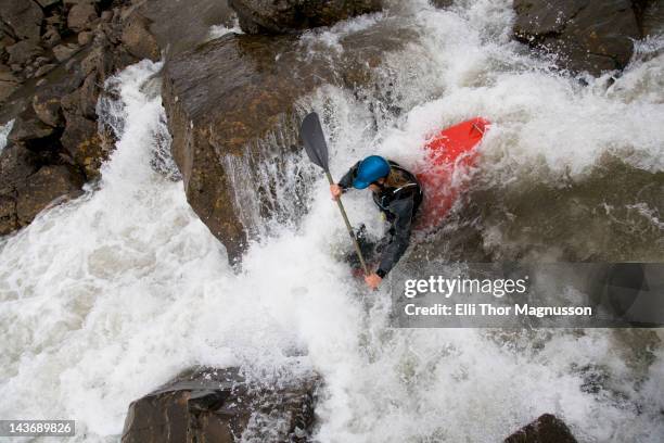 man canoeing over rocky waterfall - whitewater kayaking stock pictures, royalty-free photos & images
