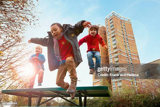 children jumping for joy in park - children only stock pictures, royalty-free photos & images