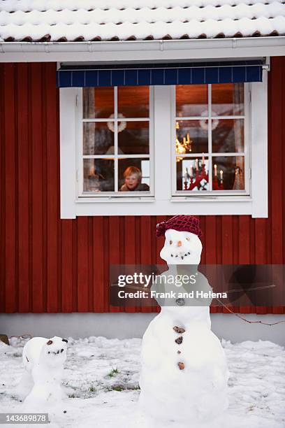 snowmen standing outside house - sweden winter stock pictures, royalty-free photos & images