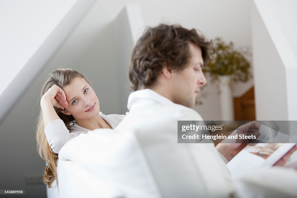 Couple relaxing together on sofa