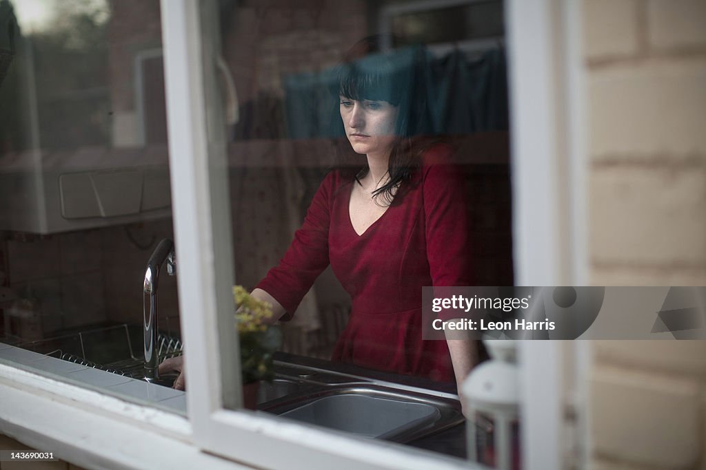 Disappointed woman standing in kitchen