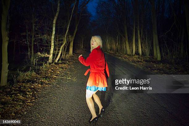 woman running in fear in woods at night - 逃げる ストックフォトと画像