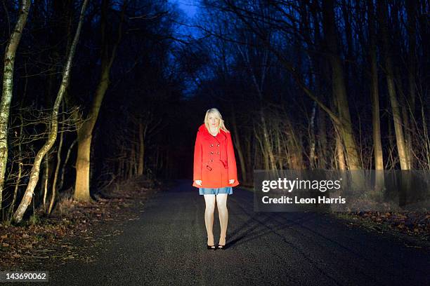 woman standing on road in woods - one night stand stock pictures, royalty-free photos & images
