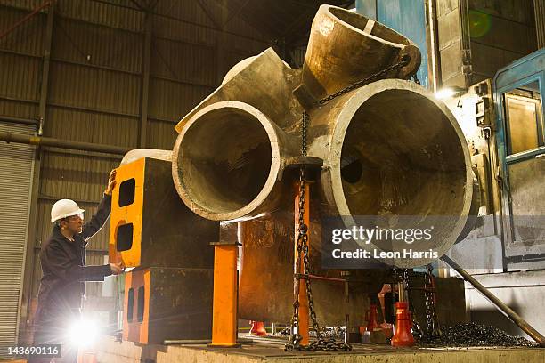 worker using machinery in steel forge - sheffield steel stock pictures, royalty-free photos & images