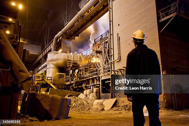 worker walking in steel forge - sheffield steel stock pictures, royalty-free photos & images