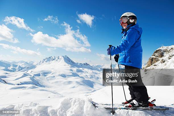 boy in skis on snowy mountaintop - ski-wear stock pictures, royalty-free photos & images