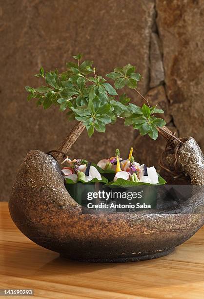 close up of plants in boat - saba sushi stockfoto's en -beelden