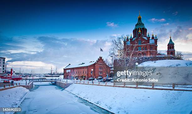 snow-covered castle by frozen river - helsinki finland stock pictures, royalty-free photos & images