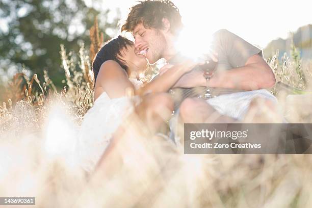 couple kissing in wheatfield - durbanville stock pictures, royalty-free photos & images